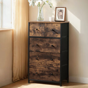 Rustic wooden dresser with a black metal frame and knobs, top adorned with a glass vase of white flowers, a small candle, and a framed photo.